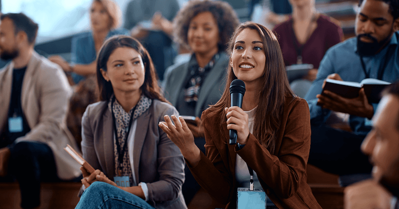 Attendee asking a question with a microphone during a session